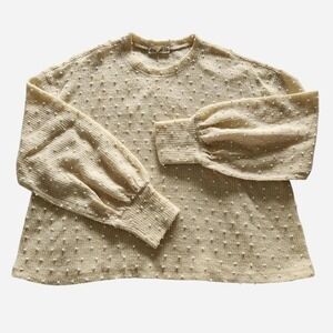 Light yellow popcorn sweater with puffy long sleeves  and white bobbles